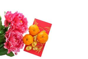 Top view of the Mandarin orange on red envelopes and gold ingot decorated with plum blossom isolated on white background. Copy space for text. Chinese New Year festival concept. photo