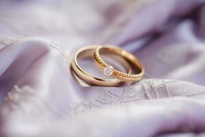 AI generated Lilac Love Wedding Rings Resting on Soft Fabric photo