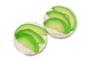 Rice Cake Sandwiches with Fresh Avocado and Cream Cheese Isolated on White. Easy Breakfast. Diet Food. Quick and Healthy Sandwiches. Crispbread with Tasty Filling. Healthy Dietary Snack Isolation photo