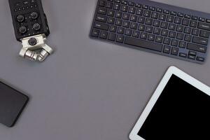 Top View of Workplace. Digital Gadgets Lying on Grey Table Flat Lay photo