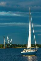 Blue sailboat in the travel by Europe. Sea journey photo