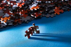 Mixed Peaces of a Colorful Jigsaw Puzzle Lie on the Blue Background Strategy and Solving Problem Concept photo