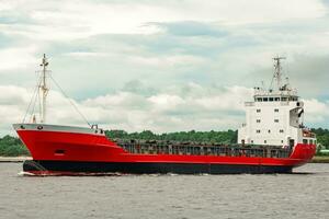 Red new cargo ship moving abroad. Product export in Europe photo