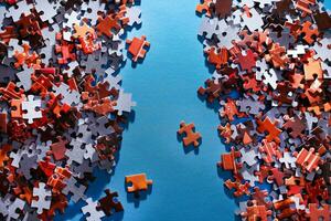 Mixed Peaces of a Colorful Jigsaw Puzzle Lie on the Blue Background Strategy and Solving Problem Concept photo