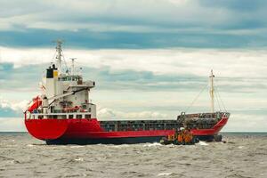 Red new cargo ship moving abroad. Product export in Europe photo