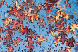 Top View of Mixed Peaces of a Jigsaw Puzzle Texture Background photo