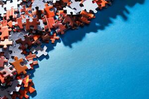 Mixed Peaces of a Colorful Jigsaw Puzzle Lie on the Blue Background With Copy Space Strategy and Solving Problem Concept photo