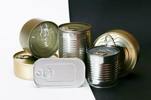 A Group of Stacked Tin Cans with Blank Edges on Split Black and White Background. Canned Food. Different Aluminum Cans for Safe and Long Term Storage of Food. Steel Sealed Food Storage Containers photo