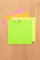 Colored Sticky Notes with Copyspace Pinned to the Wooden Message Board. To Do List Reminder in Office. Blank Memo Sticker at Work Template. Empty Checklist Mockup photo