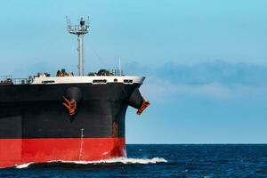 Black bulker ship. Logistics and merchandise transportations photo