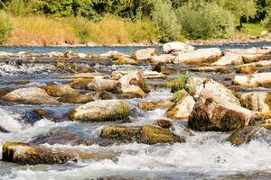 a river with rocks and water flowing over them photo