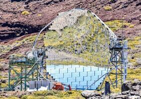 a large mirror is sitting on top of a mountain photo