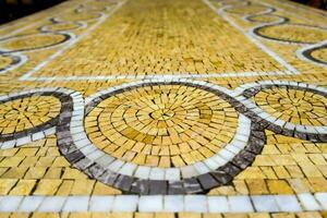 a mosaic floor with a circular design on it photo