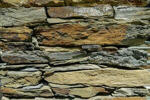 a stone wall with many different colored stones photo