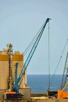 a crane is lifting a large container onto a ship photo