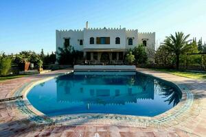 villa with pool in the middle of a large garden photo