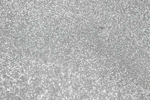 Abstract blur silver glitter sparkle defocused bokeh light background photo