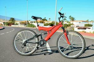 un rojo bicicleta estacionado en el lado de el la carretera foto
