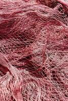 a pile of red fishing nets photo