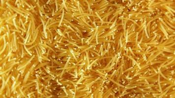 Background of Uncooked Noodles that Rotating Counterclockwise Top View, CloseUp. Texture of Dry Vermicelli Turning Around. Raw Pasta with Low Key Light Left Rotation video