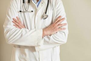 Portrait of male doctor with arms crossed. photo