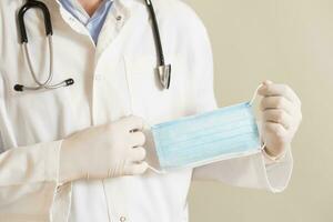 Image of male doctor showing surgical mask photo