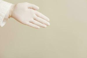 Image of close up hand in protective glove of doctor showing. photo