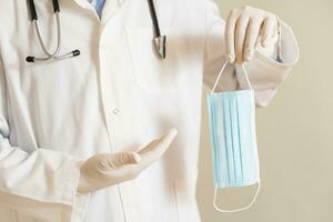 Image of male doctor showing surgical mask photo