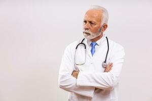 Image of  angry senior doctor on gray background. photo