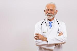 Portrait of senior doctor thinking on gray background. photo