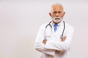 Image of  angry senior doctor on gray background. photo