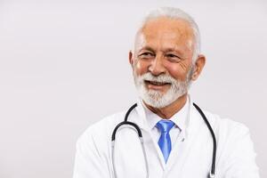 Portrait of senior doctor thinking on gray background. photo