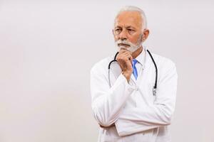 Image of worried  senior doctor thinking on gray background. photo