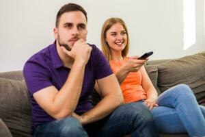 Angry wife and husband are having conflict because wife is watching tv too much. photo