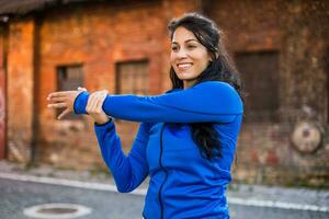 Beautiful woman enjoys exercising outdoor. photo