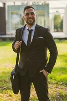 Portrait of elegant businessman enjoys standing outdoor.Toned photo. photo