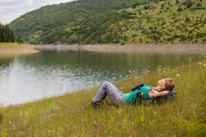 Woman hiker enjoys  resting in the beautiful nature. photo
