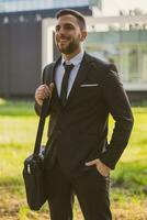 Portrait of elegant businessman enjoys standing outdoor.Toned photo. photo