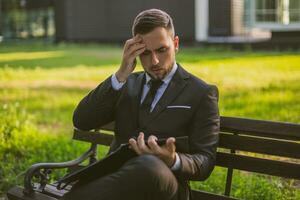 Worried businessman working outdoor.Toned photo. photo