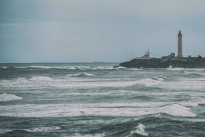 Image of sea and lighthouse in Morocco. photo