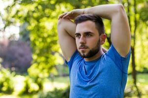 Handsome man exercising in the park. photo