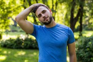 Handsome man exercising in the park. photo