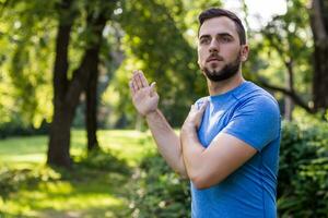 Handsome man exercising in the park. photo
