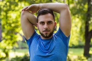 Handsome man exercising in the park. photo