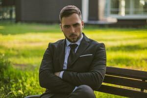 Angry businessman sitting outdoor.Toned image. photo