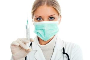 Doctor with protective mask and syringe photo