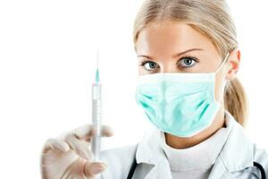 Doctor with protective mask and syringe photo