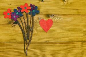 Image of  flowers with heart shape on wooden table.Toned photo. photo