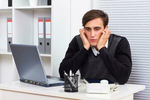 Depressed businessman at work photo