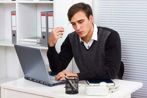 Businessman thinking while working photo